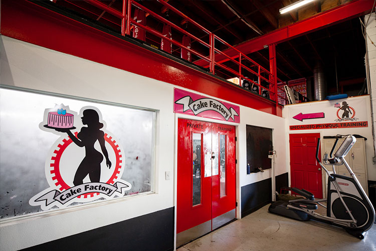 The red Cake Factory doors and painted logo inside Boulevard Fitness